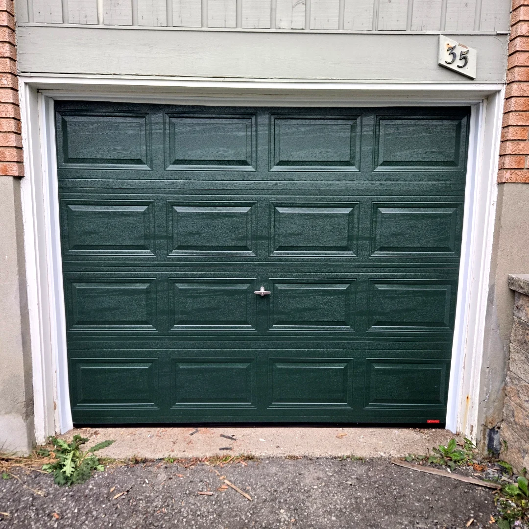 After — TOHO Classic 300 short-panel garage door in deep Evergreen installed by Liftime at the same Ottawa townhome