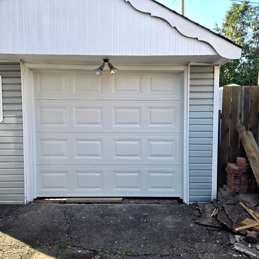 After — Fresh TOHO Classic 300 short-panel garage door in White installed cleanly on the same Ottawa back-lane garage by Liftime