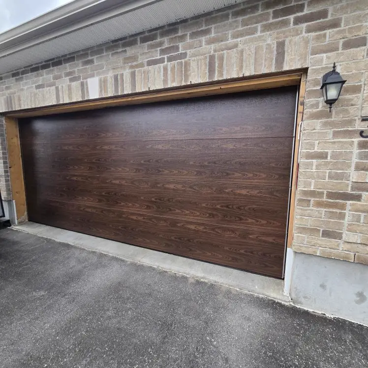 After — New dark walnut woodgrain flush double-car garage door installed by Liftime Ottawa