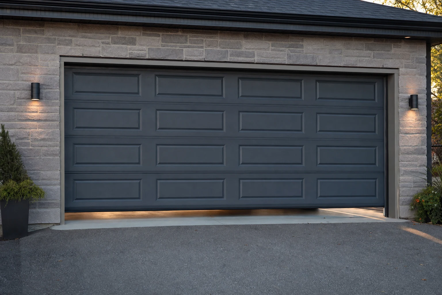 Modern garage door stopped a few inches above the driveway with daylight visible underneath