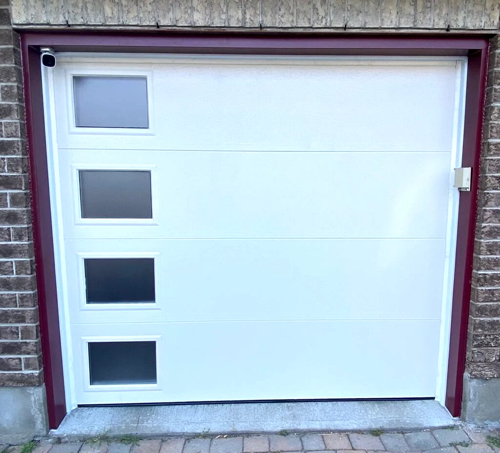 Clean burgundy aluminum capping installed around a white modern garage door in Ottawa by Liftime, weather-tight finish