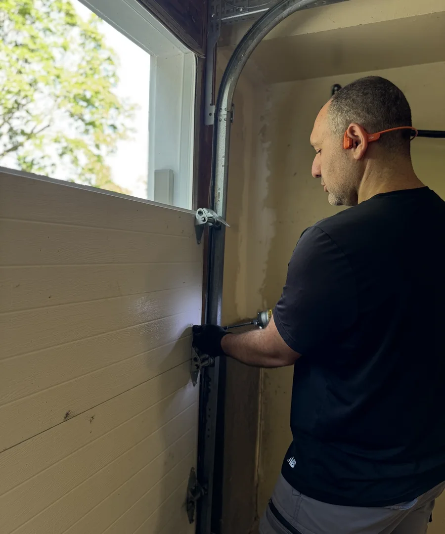 Michael Bakov installing aluminum capping on Ottawa garage door frame