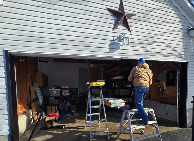 Liftime owner Michael installing aluminum capping on an Ottawa garage door frame