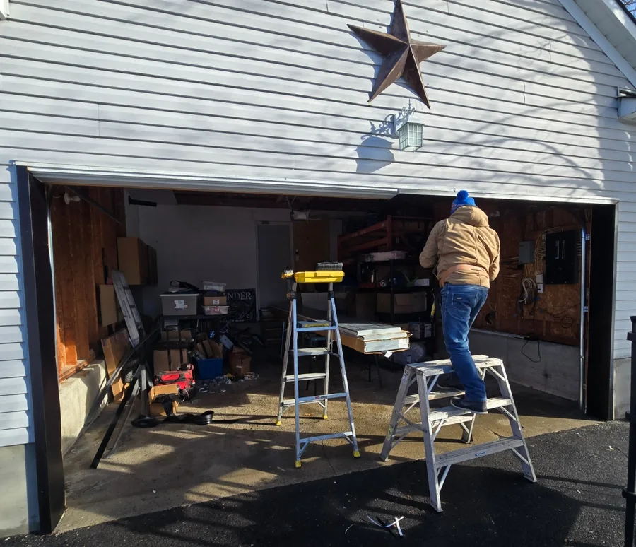 Michael Bakov installing aluminum capping on an Ottawa garage door