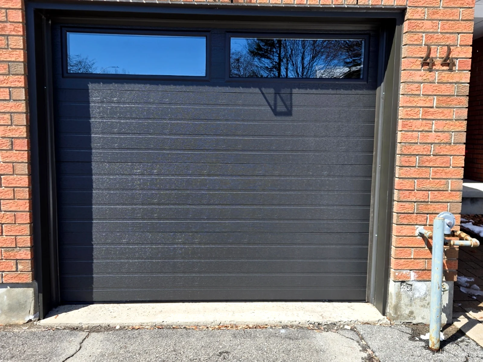 TOHO Flush 800 dark garage door with wide top windows at #44 in Ottawa, installed by Liftime