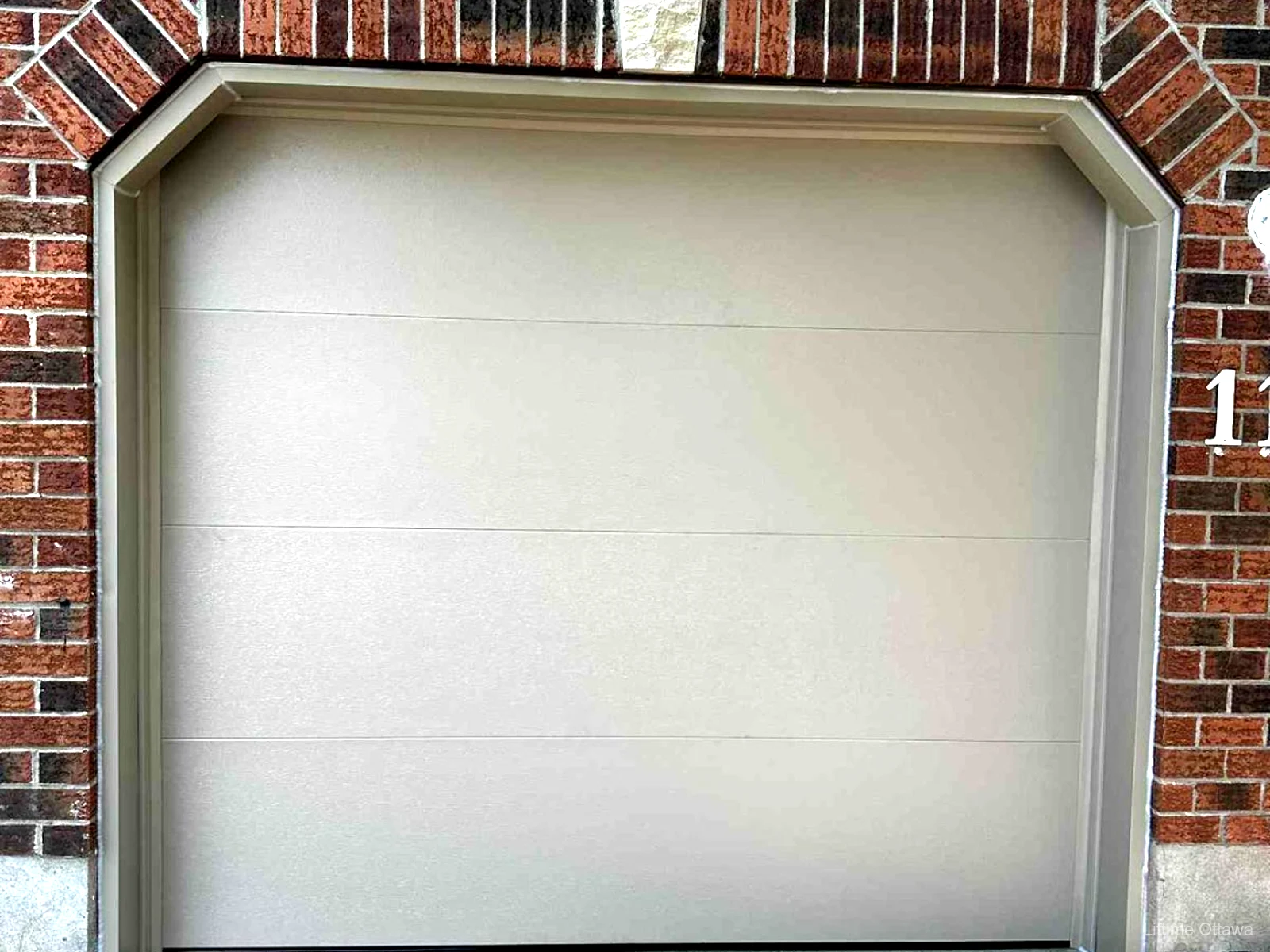 TOHO Flush 800 sandstone garage door with capping detail, installed by Liftime in Ottawa