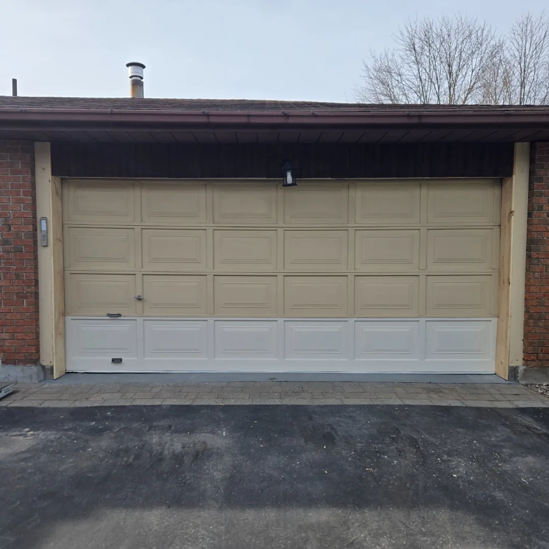 Sandstone double raised-panel garage door on brick Ottawa home during installation by Liftime