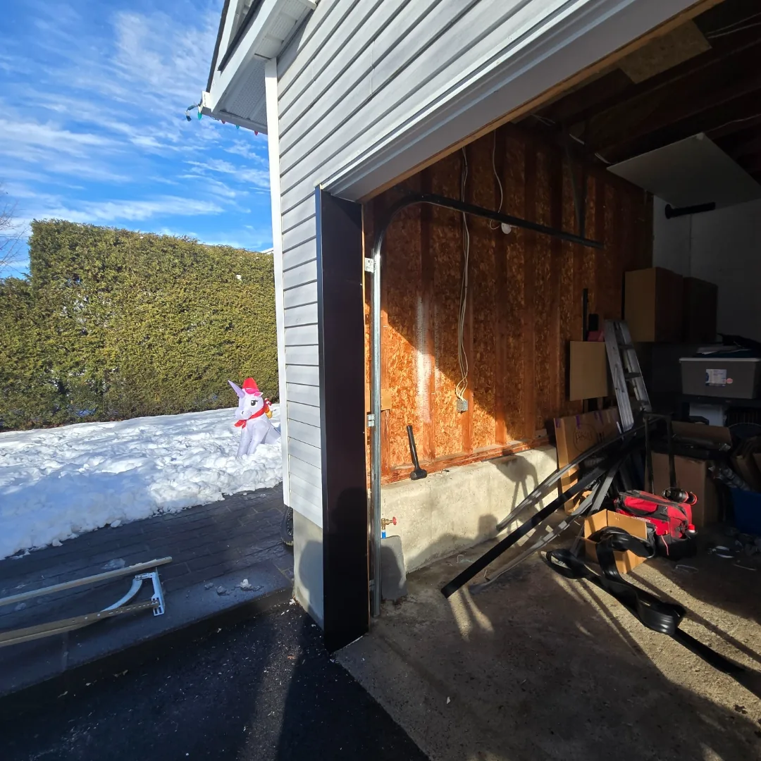White raised-panel garage door installation on brick Ottawa home by Liftime