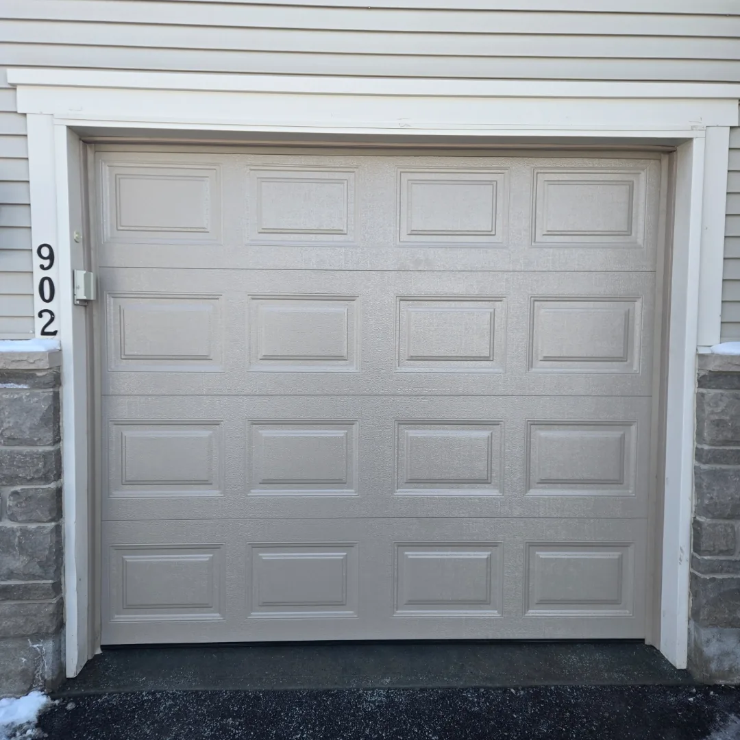 Sandstone raised-panel garage door on brick Ottawa home address 2241, installed by Liftime