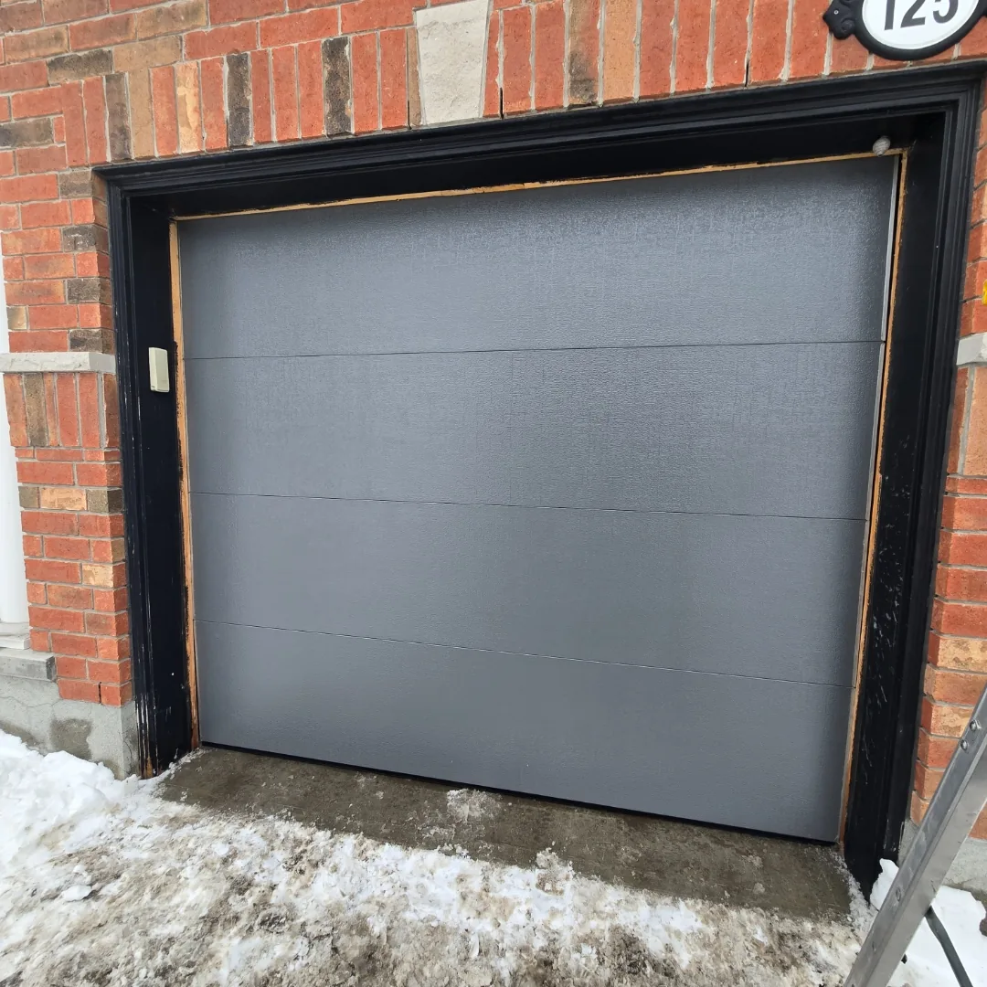 Brown double raised-panel garage doors on Ottawa home, installed by Liftime