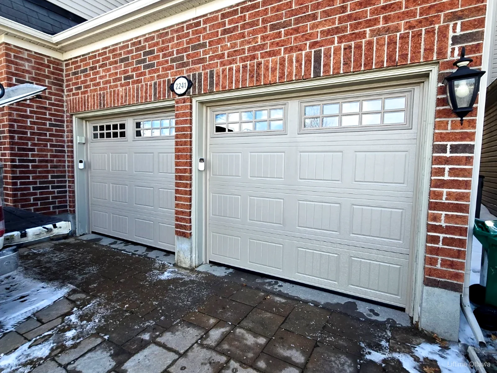 TOHO Coach House 400 sandstone insulated garage door with carriage-style windows, installed by Liftime