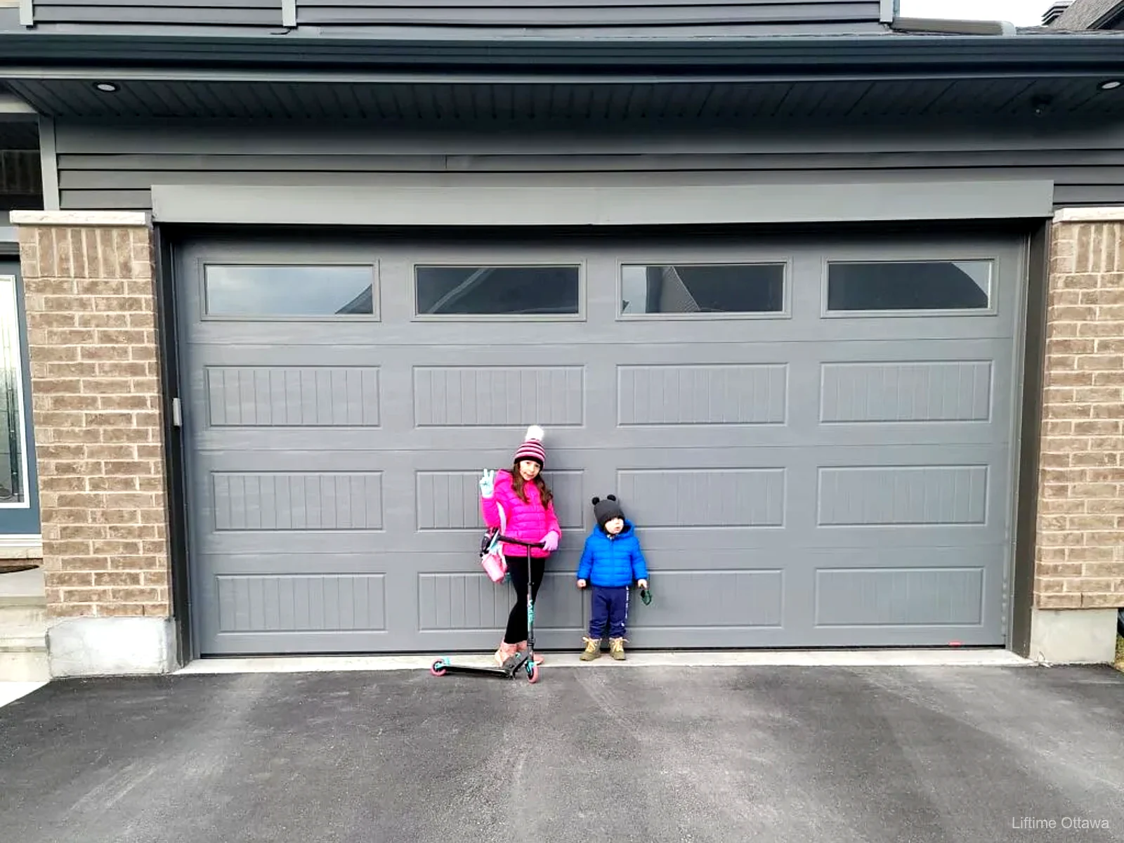 TOHO grey garage door with top windows installed by Liftime on an Ottawa family home