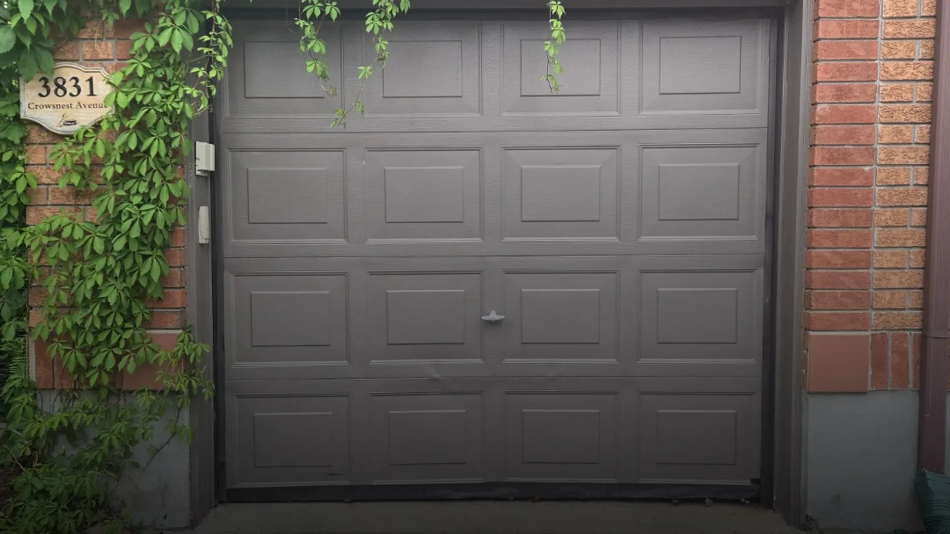 Kanata garage door repair — Ottawa brick home with new insulated steel door installed by Kanata Garage Door Service