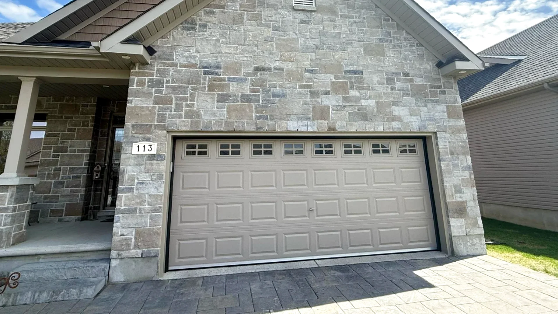 Stone-front Ottawa home with a new carriage-style garage door installed by Liftime — door selection guide