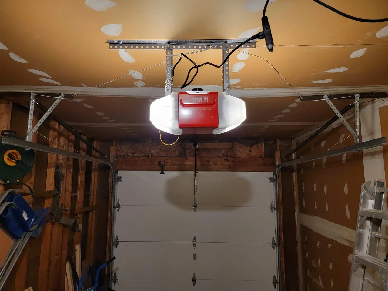 Ceiling-mounted garage door opener with motor head and rail in an Ottawa garage