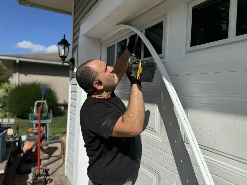 Liftime owner Michael drilling into a garage door frame during a residential repair in Ottawa